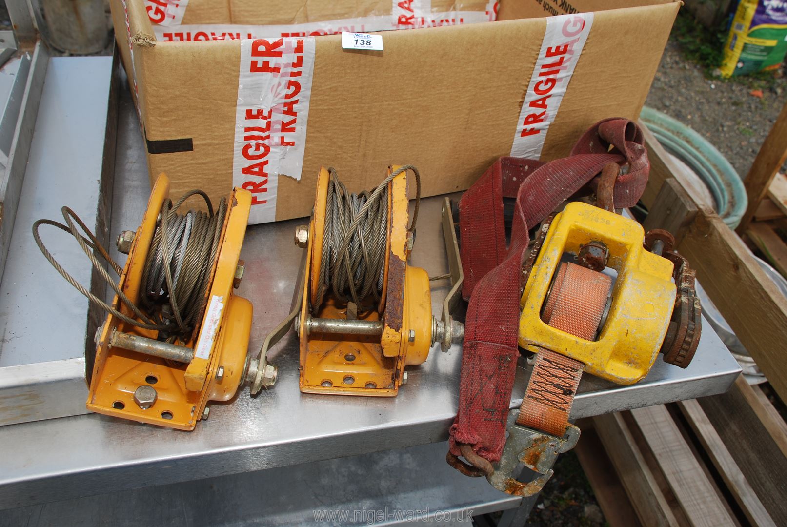 Two wire rope trailer hand winches and a strap hand-winch.