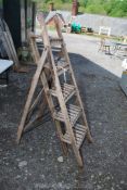 A four rung wooden stepladder.