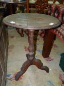 A circular mixed woods occasional Table standing on a turned pillar and with three fretworked splay