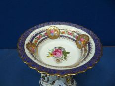 A porcelain centrepiece having hand painted flowers in reserves,