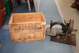 A vintage Sewing Machine by Willcox & Gibbs in a 'Kynoch' Birmingham safety cartridges wooden crate.