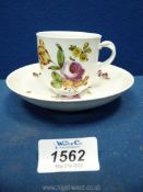 A mid 18th c. Vienna porcelain cup and saucer painted flowers, the cup chipped.