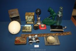 A quantity of miscellanea including an Ostrich egg, quartz clock, lamp, car horn, green doorstop,