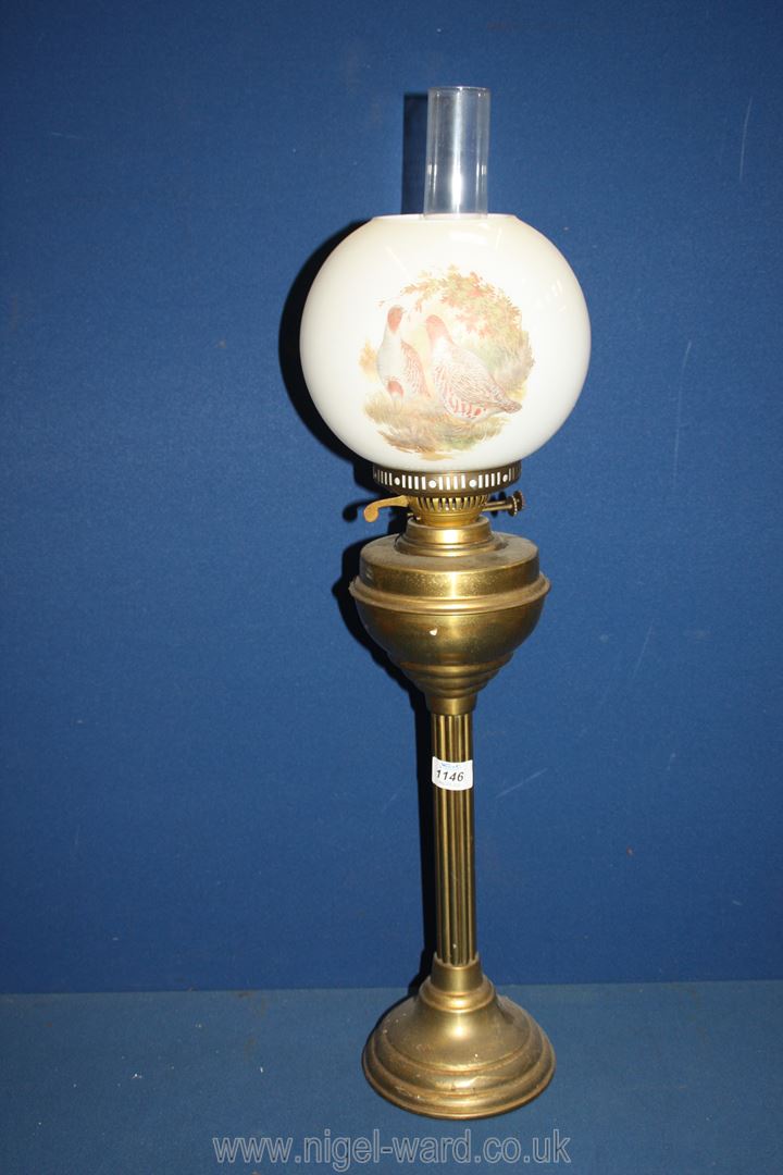 An Oil Lamp with reeded brass base,