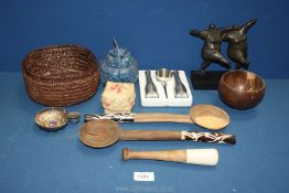 A pair of wooden salad servers with bone handles, sculpture of two ladies, metal wine tasting cup,