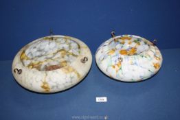 Two art deco glass pendant light shades, one white and yellow mottled,