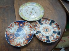 Three oriental plates, two blue and one orange design (one a/f.