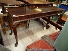 A cross-banded topped Mahogany serving Table having a blind fretwork frieze,