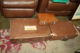 Two large old leather suitcases plus a small leather vanity case.