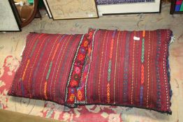A pair of vintage handmade Afghan saddle bags, made up as cushions for conservatory or sofas,