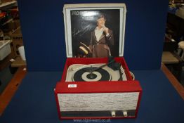 A Dansette Viva record player in red and cream case.