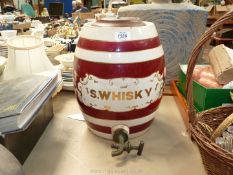 A large porcelain Whisky barrel with brass tap a/f. in burgundy and white with gold wording "S.