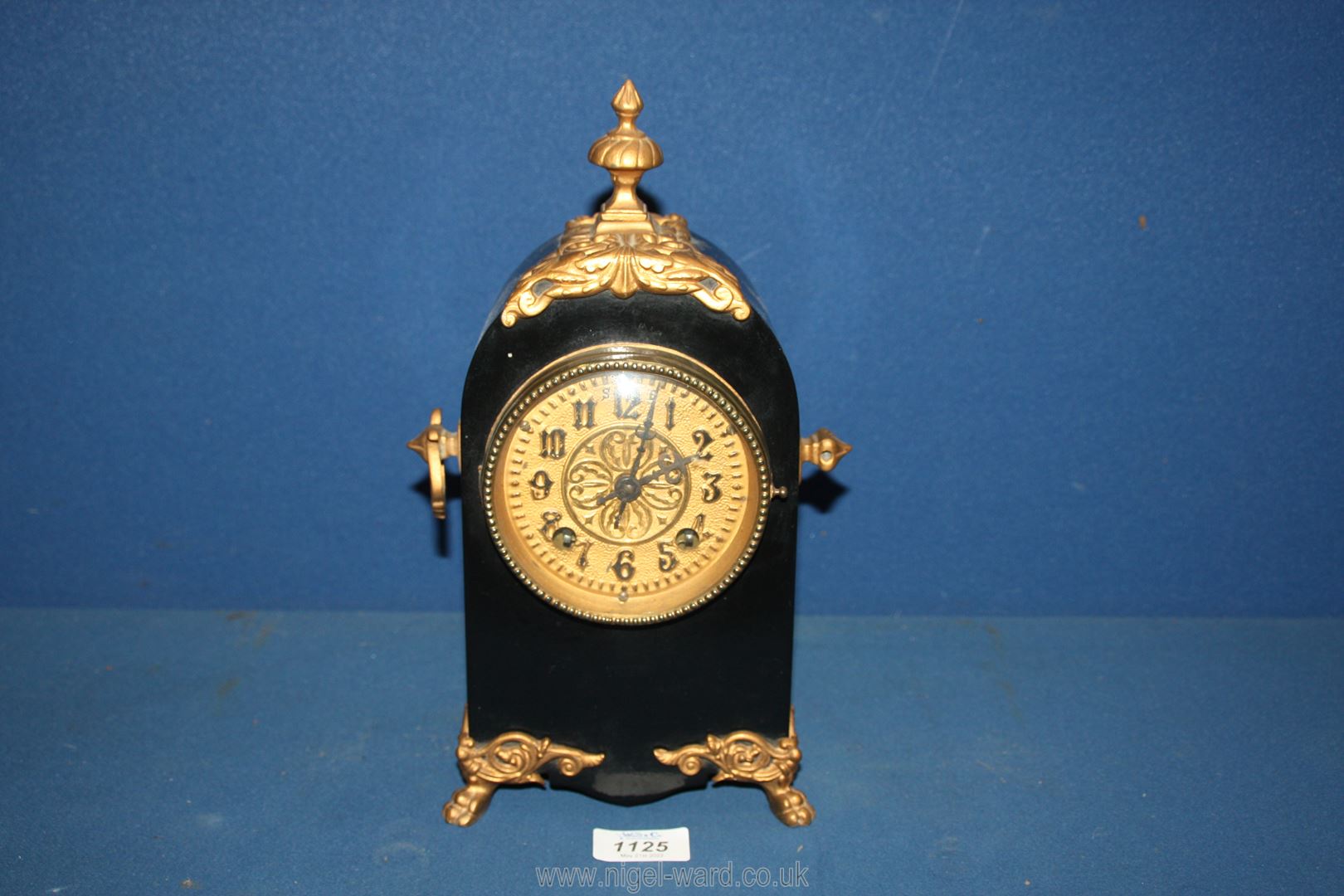 A Mantle Clock marked 'Riviera Malachite, New Haven', black with gilding,
