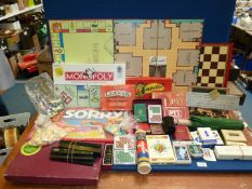 A box of assorted board games, cards etc. including Pit, Monopoly, Dominoes and Sorry.
