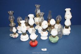 A good variety of miniature oil lamps including Pyrex rose pattern, glass, metal and brass,