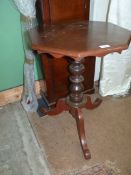 A mixed woods octagonal occasional Table standing on a turned pillar and three splay feet,