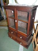 An appealing double doored glazed Cabinet having a pair of short drawers below,