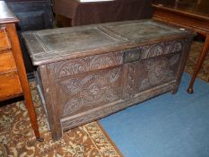 A two panel peg joyned Oak Blanket Chest having carved panels and top and bottom rails,