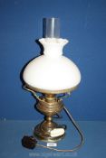 A Brass oil lamp with chimney and white shade,