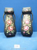A pair of black ceramic handled vases with pink flower decoration, 11 1/2" tall.