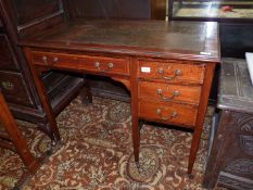 An Edwardian Mahogany writing Desk having a cross-banded and lightwood strung top with inset brown