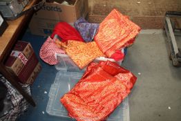 A quantity of red and orange textiles including satin damask brocade,