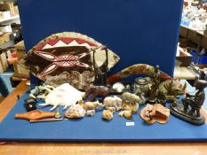 A variety of miscellanea including stone elephants and other animal figures, Conch shell, boomerang,