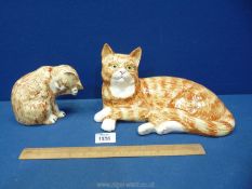 A large Moorland Devon Pottery Cat in ginger and cream with white paws and muzzle and green eyes in