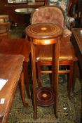 A lightwood strung Mahogany Jardiniere Stand having shaded inlay to the centre and standing on