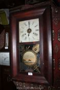A darkwood cased American wall Clock having a two train weight driven movement striking on a gong,