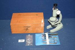 A small cased Microscope with tools and specimen glass slides, 8 3/4'' tall.