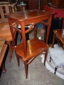 A pair of Mahogany occasional Tables having serpentine edged tops and standing tapering square