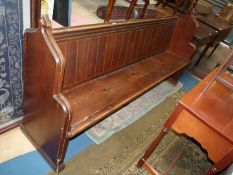 A stained Pine Pew, 80 3/4'' long x 19 1/4'' deep x 39 3/4'' high, the seat 17'' high approx.