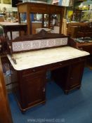 A Victorian Mahogany white marble topped kneehole Washstand having a tiled up-stand,