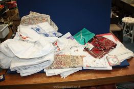 A box of linen including handkerchiefs, table cloths, embroidery etc.