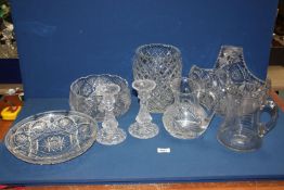 A quantity of glass items including star cut fruit bowl, basket, water jug, candlesticks etc.