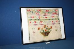 An alphabet sampler also embroidered with a basket of flowers by Ann Mary Whitehead aged 10,