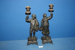 A pair of black metal candlesticks in the form of Lady and Gentleman, 15" tall.