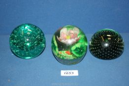 Three paperweights including pale green bubbles, pink floral etc.