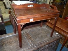 An early 20th c. Mahogany Tray/Table having fretworked handle recesses, 25'' x 14 3/4'' x 21'' high.