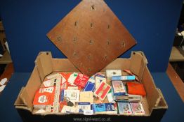 A box of playing cards, Hula hoop board game and a Cribbage board.