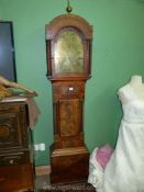 A Mahogany cased eight day Longcase Clock having an arched brass face with inset second hand and