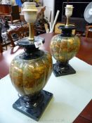 An impressive Pair of table lamps having marble effect body on square dark green bases,