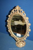 A decorative gilt metal mirror on stand 16" tall.