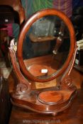 A Mahogany oval swing mirror with hinged round lidded jewellery box to the front, 23" tall.