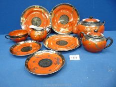 A part Japanese Teaset in orange and black .