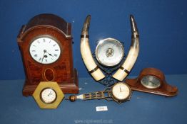 A quantity of clocks including wooden mantle clock, a barometer with horns surmounted either side,