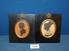 Two Victorian silhouette Portraits in oval and black frames of young women;