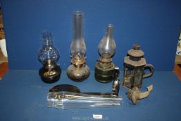 A quantity of oil lamps including metal and glass bases, complete with chimneys.