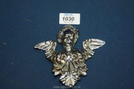 A chrome Cherub Car Badge with registration mark to verso, 5" wide x 5" tall.